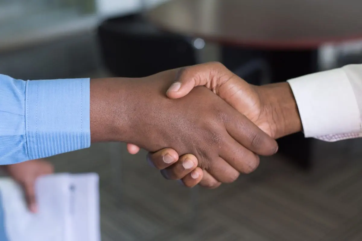 Two people shaking hands.